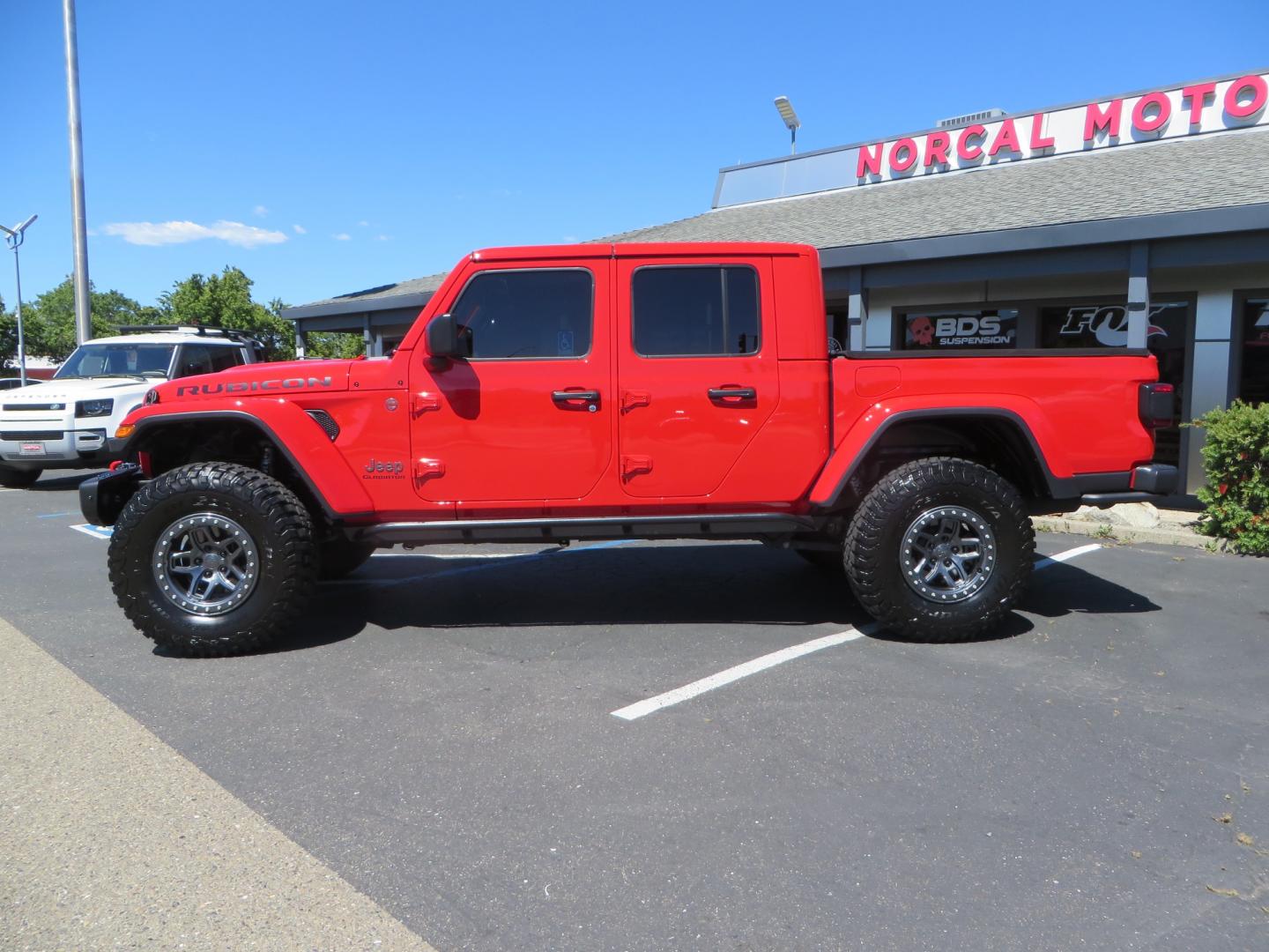 2020 Red /black Jeep Gladiator Rubicon (1C6JJTBG6LL) with an 3.6L V6 DOHC 24V engine, 6M transmission, located at 2630 Grass Valley Highway, Auburn, CA, 95603, (530) 508-5100, 38.937893, -121.095482 - Rubicon Gladiator featuring a Mopar suspension system with Fox shocks, 17" AEV wheels wrapped in 37" BFG tires, Warn Winch, Rock sliders, Cascade front license plate holder, Impact bedliner, Built Right Industries bed Molle panels, and Window tint. - Photo#7